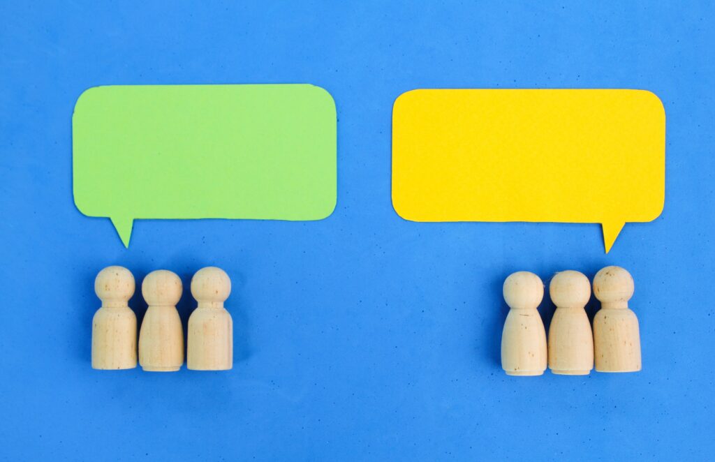 Illustration of misaligned sales conversation bubbles representing inconsistent messaging in sales, highlighting the need for a CRO playbook to align B2B SaaS sales team messaging.
