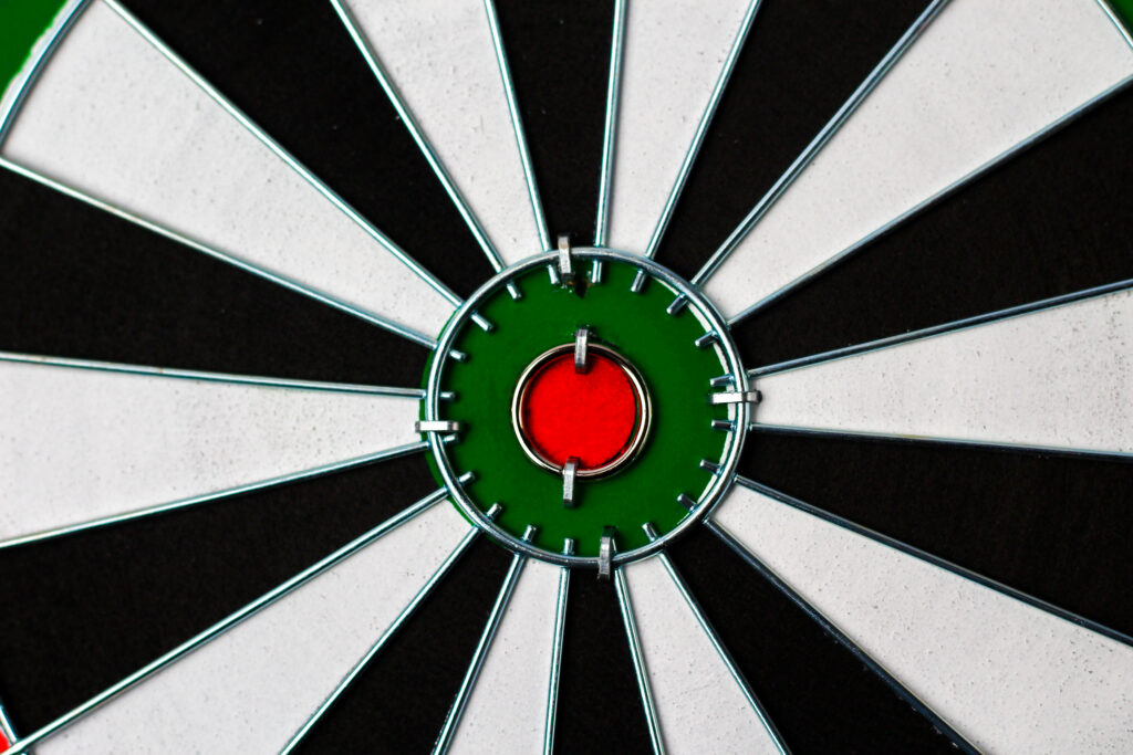 Close-up of a dartboard with a dart in the bullseye, symbolizing focused targeting
