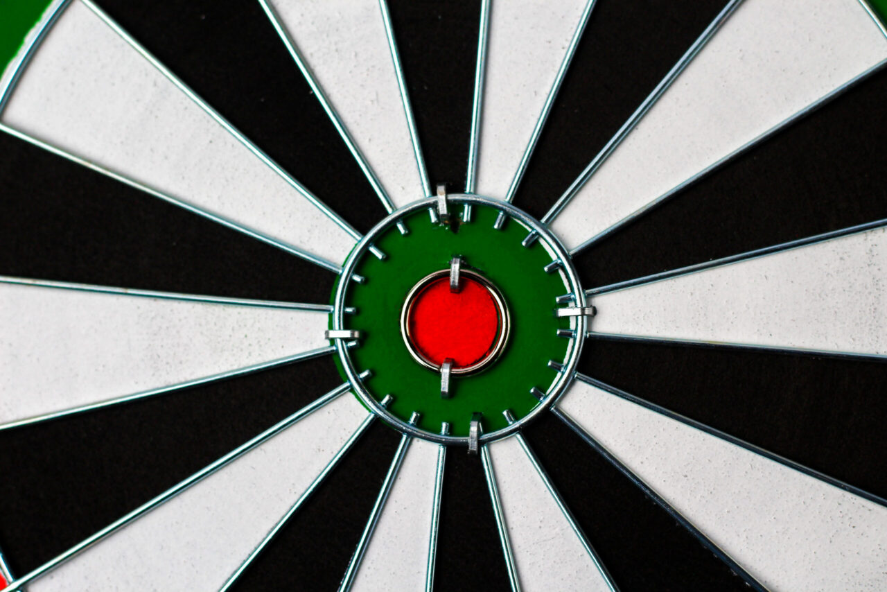 Close-up of a dartboard with a dart in the bullseye, symbolizing focused targeting