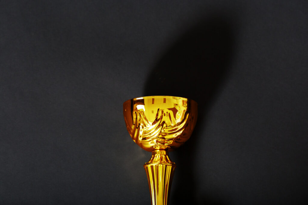 Gold trophy on a dark background representing top quality and recognition