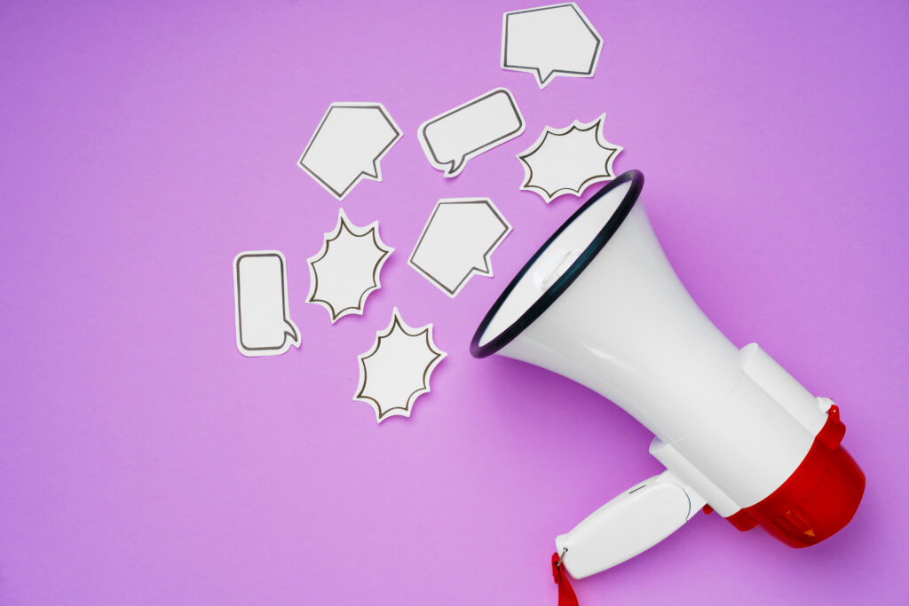 Megaphone with speech bubbles on a purple background representing clear messaging