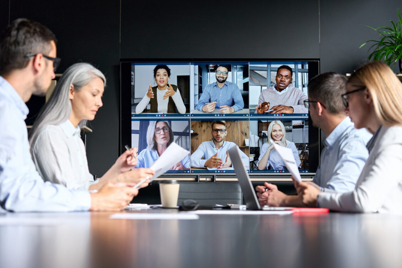 Diverse team joining a video conference call in a meeting room